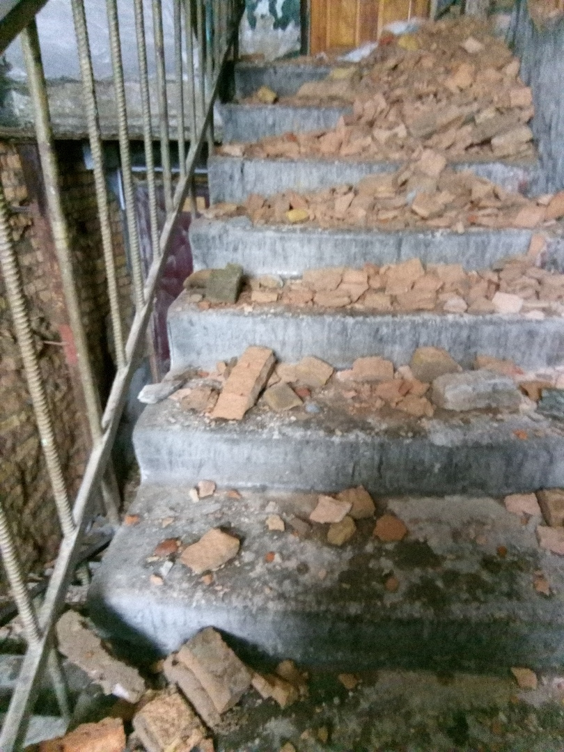 В жилом доме в центре Сыктывкара обвалилась кирпичная стена и завалила лестницу в подъезде (фото)